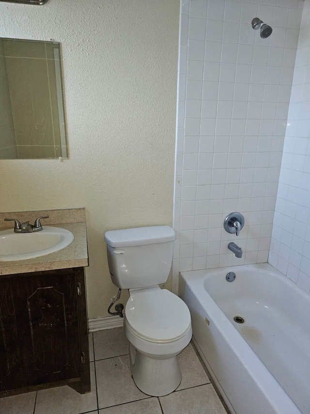 full bathroom with toilet, tile floors, tiled shower / bath combo, and vanity