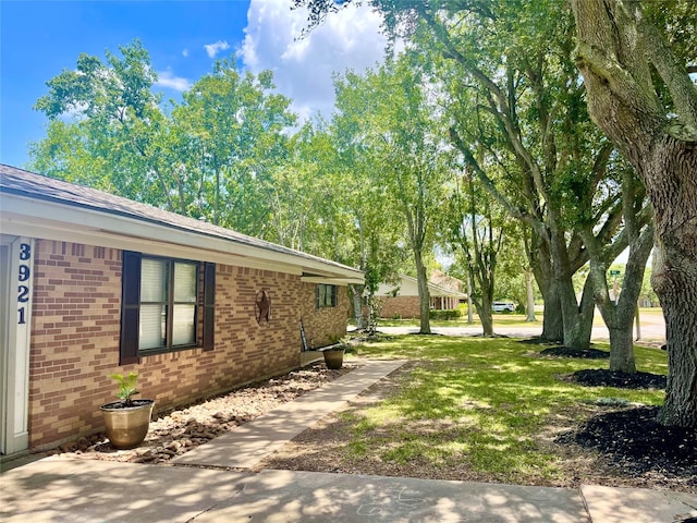 view of property exterior with a lawn