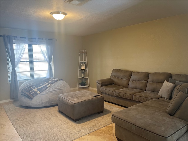 tiled living room featuring a textured ceiling