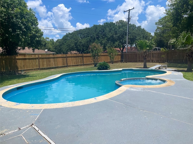 view of pool featuring a patio and a yard