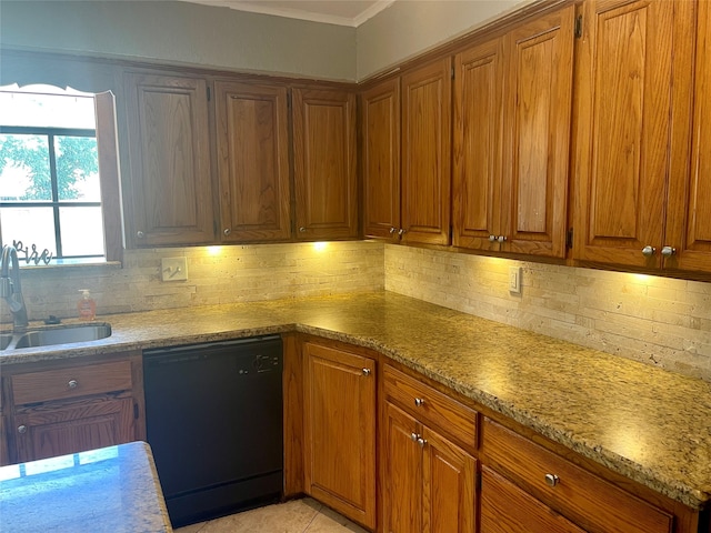 kitchen with light stone countertops, backsplash, dishwasher, and sink