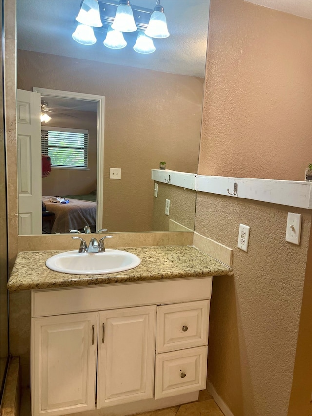 bathroom featuring ceiling fan and vanity