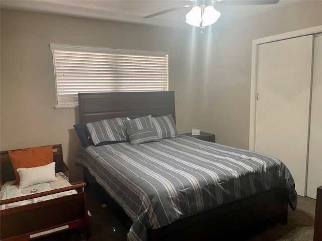 carpeted bedroom featuring ceiling fan, a closet, and multiple windows