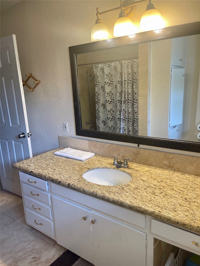 bathroom with large vanity and tile floors