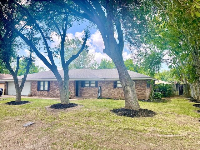 single story home with a front lawn and a garage