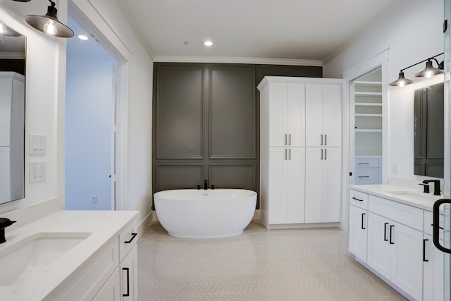 bathroom featuring crown molding, a bath to relax in, tile floors, and dual vanity