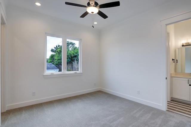 unfurnished room with light colored carpet, ceiling fan, and crown molding