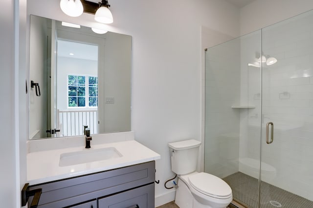 bathroom featuring walk in shower, toilet, and large vanity