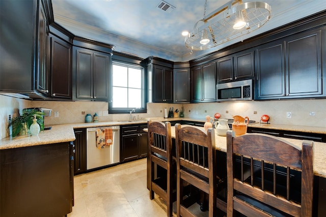 420 Heights Blvd, Houston, TX 77007 - kitchen featuring appliances with stainless steel finishes, ornamental molding, light stone counters, decorative backsplash, and hanging light fixtures