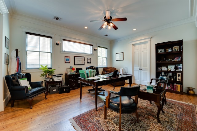 home office with plenty of natural light, light hardwood / wood-style floors, crown molding, and ceiling fan