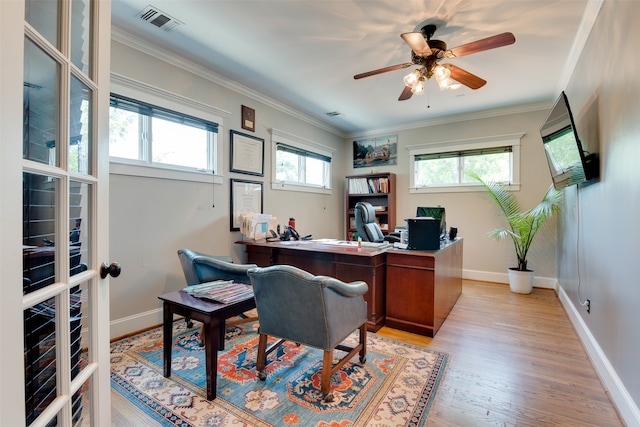 office area featuring plenty of natural light, ceiling fan, french doors, ornamental molding, and light wood-type flooring