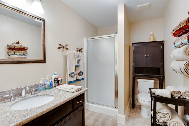 bathroom with toilet, tile floors, an enclosed shower, and vanity