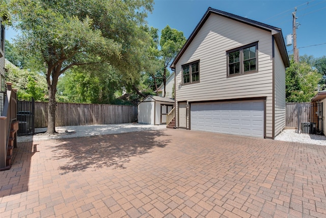 420 Heights Blvd, Houston, TX 77007 - view of property exterior with an attached garage, a storage unit, and decorative driveway