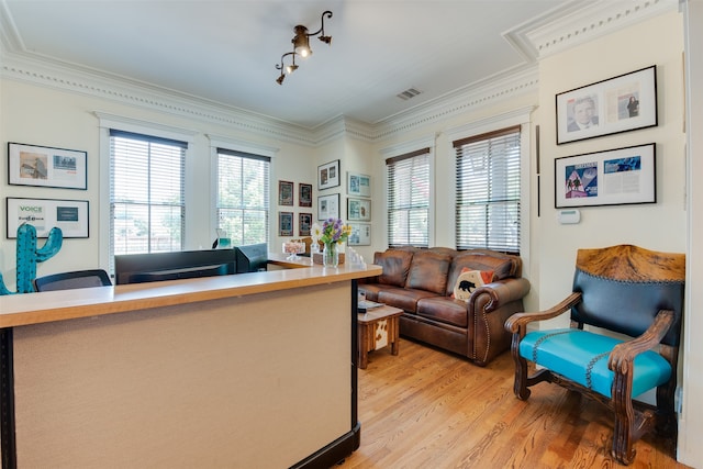 office area with ornamental molding and light hardwood / wood-style floors