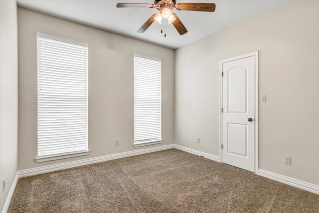 spare room with a healthy amount of sunlight, ceiling fan, and carpet floors