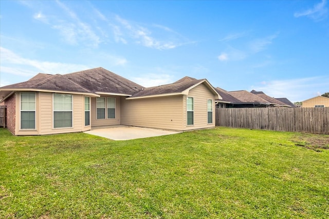 back of property featuring a patio and a yard