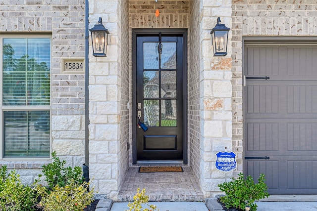 view of exterior entry featuring a garage