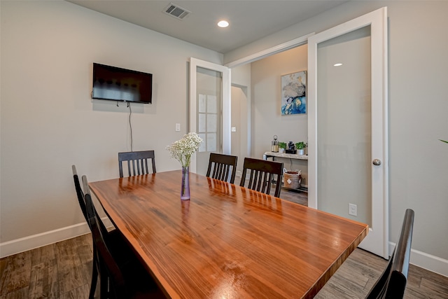 dining room with dark hardwood / wood-style flooring