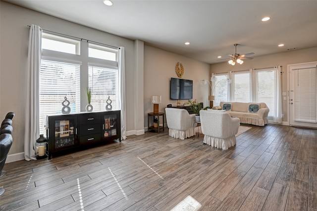 interior space with ceiling fan, plenty of natural light, and wood-type flooring