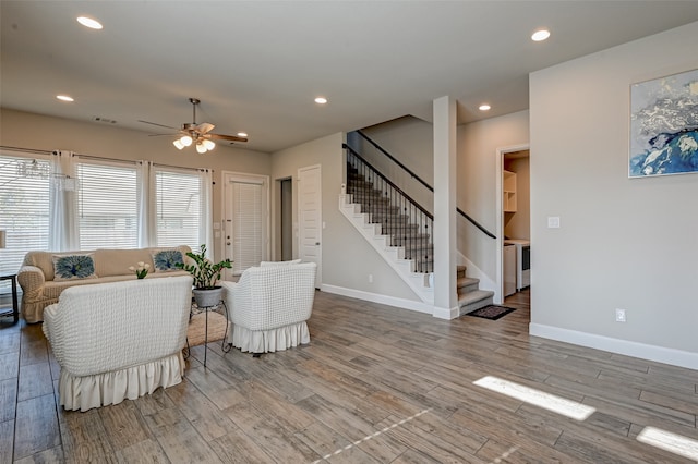 living room with hardwood / wood-style floors and ceiling fan