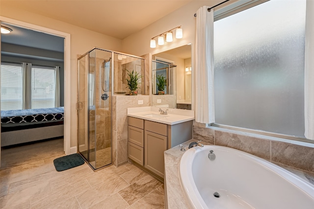 bathroom featuring tile flooring, large vanity, and separate shower and tub