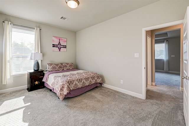 bedroom featuring light carpet