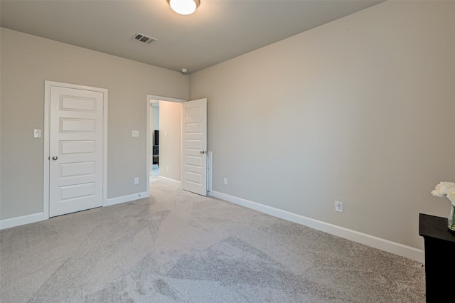 empty room featuring light colored carpet