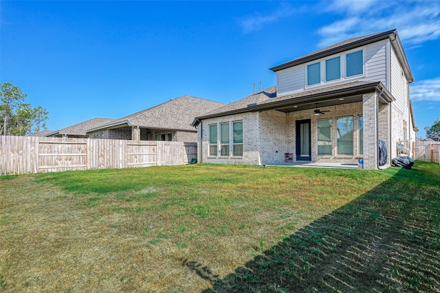 back of house with ceiling fan, a patio area, and a yard