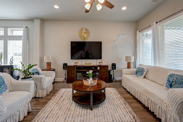 living room with ceiling fan and light wood-type flooring