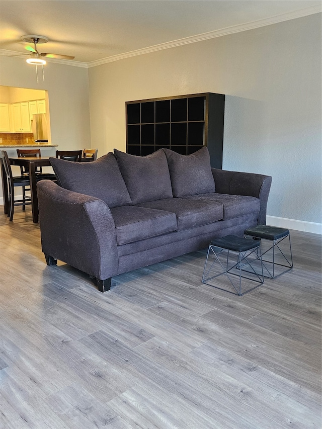 living room with ornamental molding, ceiling fan, and hardwood / wood-style floors