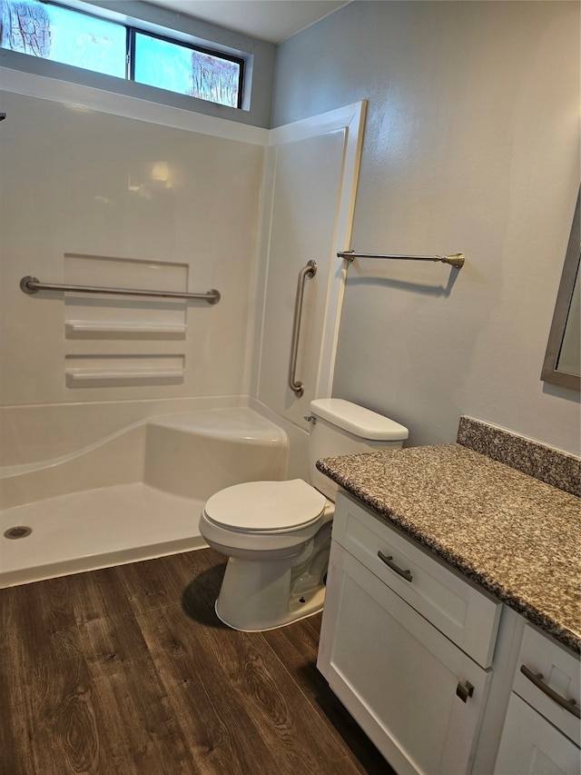 bathroom featuring vanity, toilet, and hardwood / wood-style flooring