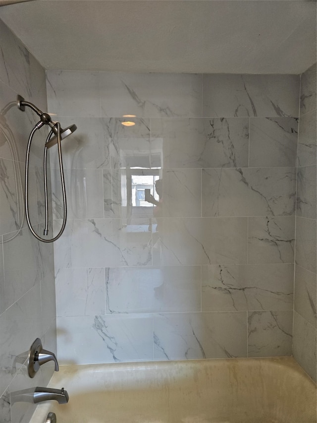 interior space with tiled shower / bath combo