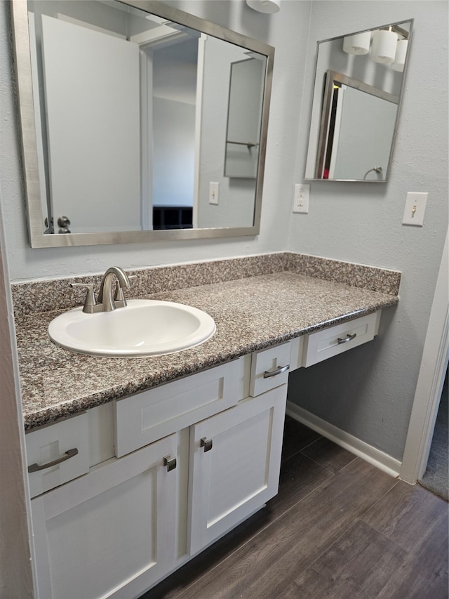 bathroom with hardwood / wood-style floors and vanity