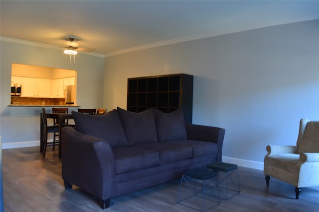 living room with dark hardwood / wood-style flooring, ceiling fan, and crown molding