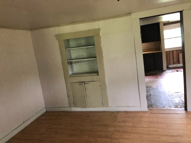 interior space featuring built in shelves and light wood-type flooring