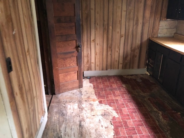 bathroom featuring wooden walls