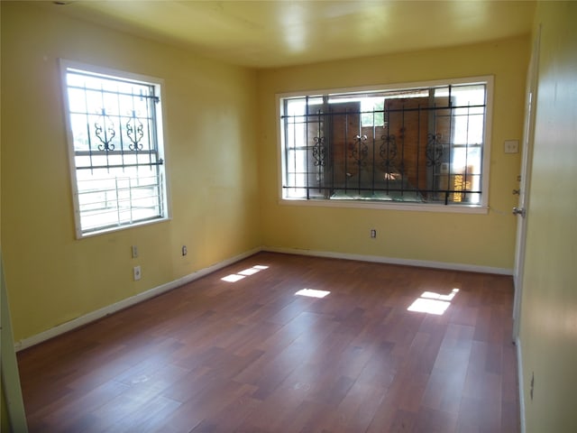 spare room with dark hardwood / wood-style floors