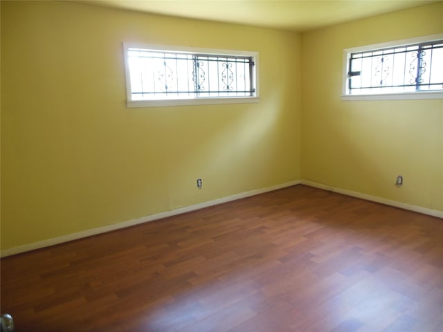 unfurnished room with hardwood / wood-style floors