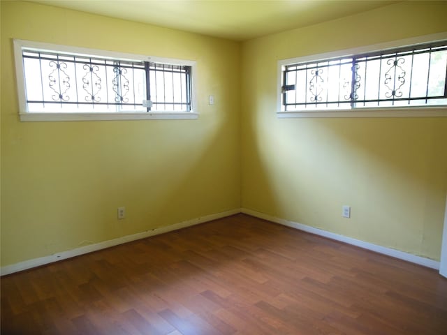 spare room featuring dark wood-type flooring