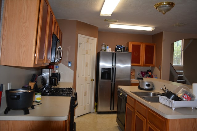 kitchen with light tile flooring, sink, and stainless steel appliances