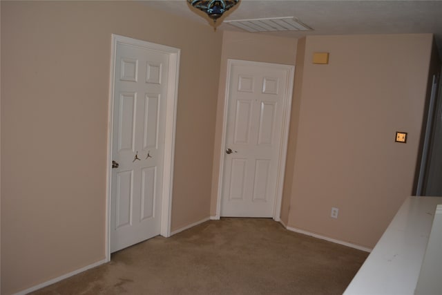 unfurnished bedroom featuring light colored carpet