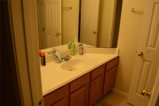 bathroom featuring tile flooring and vanity