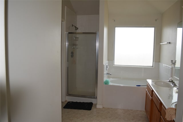 bathroom featuring tile flooring, separate shower and tub, and vanity