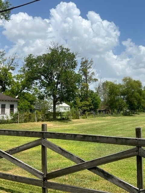 exterior space with a rural view and a yard