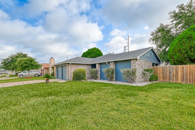 single story home featuring a front lawn and a garage