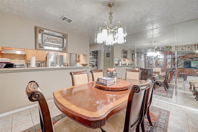 7635 Loro Linda Dr, Houston, TX 77083 - dining area with tile patterned floors, visible vents, a textured ceiling, and a chandelier