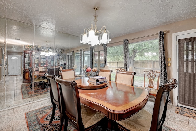 7635 Loro Linda Dr, Houston, TX 77083 - dining area featuring light tile patterned floors, a notable chandelier, and a textured ceiling