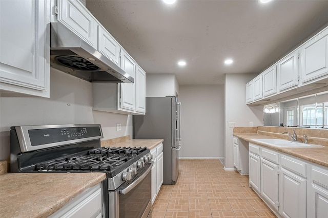 7635 Loro Linda Dr, Houston, TX 77083 - kitchen with under cabinet range hood, a sink, white cabinetry, recessed lighting, and stainless steel appliances