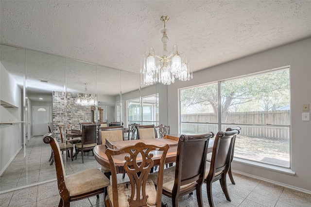 7635 Loro Linda Dr, Houston, TX 77083 - dining area with a notable chandelier, a textured ceiling, and baseboards