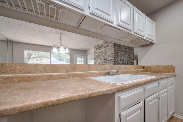 7635 Loro Linda Dr, Houston, TX 77083 - kitchen with a sink, plenty of natural light, white cabinets, and light countertops